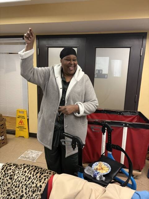 A 3Keys resident of Welcome House tries on her new coat from WSB-TV's Brad Nitz Coat Drive.