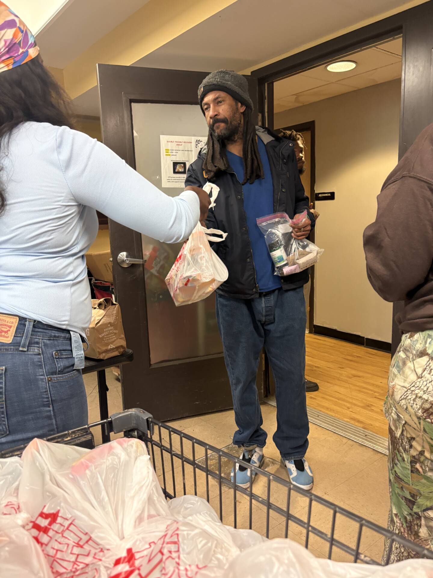 3Keys staff members hand out hygiene kits to residents of Welcome House, a permanent supportive housing apartment complex for formerly homeless individuals