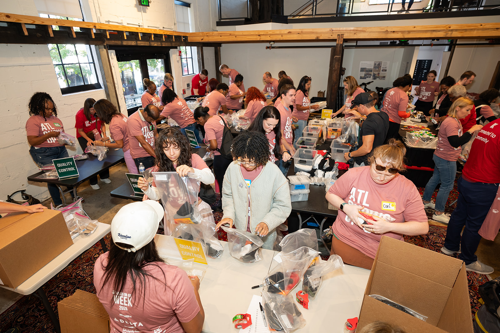 A room full of volunteers packing hygiene kits at Hands On Atlanta Week 2026 benefitting 3Keys and Welcome House