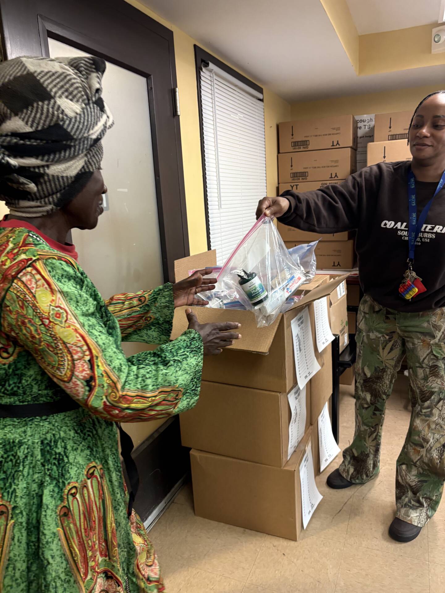 3Keys staff members hand out hygiene kits to residents of Welcome House, a permanent supportive housing apartment complex for formerly homeless individuals