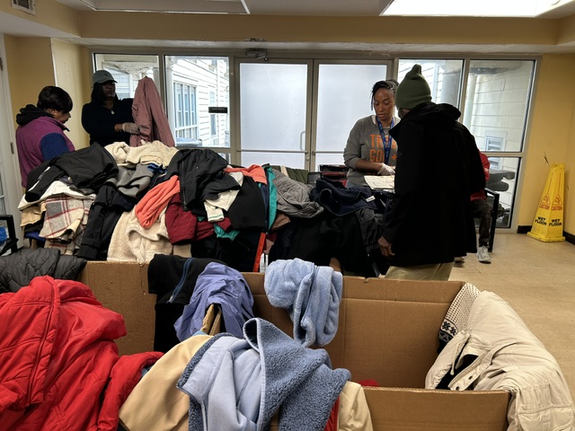 3Keys residents look through donated coats laid out on tables at Welcome House in Atlanta.