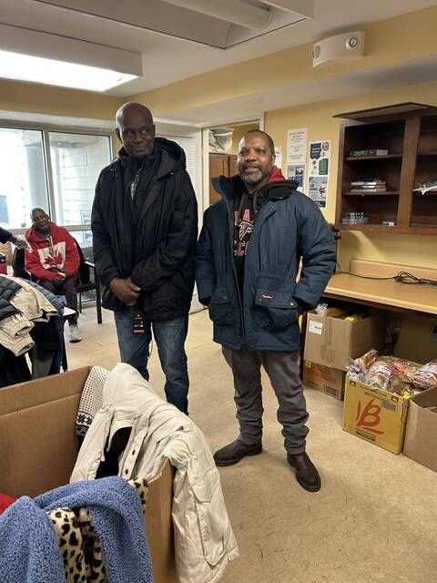 Two residents of Welcome House in Atlanta try on their new coats from WSB-TV's Brad Nitz Coat Drive.