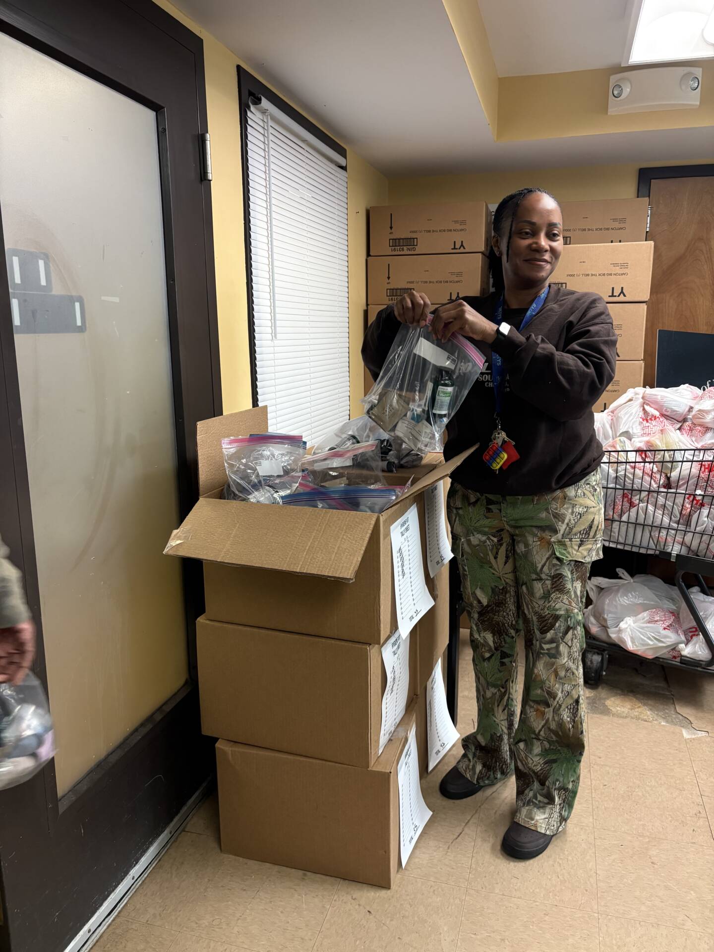 3Keys staff members hand out hygiene kits to residents of Welcome House, a permanent supportive housing apartment complex for formerly homeless individuals