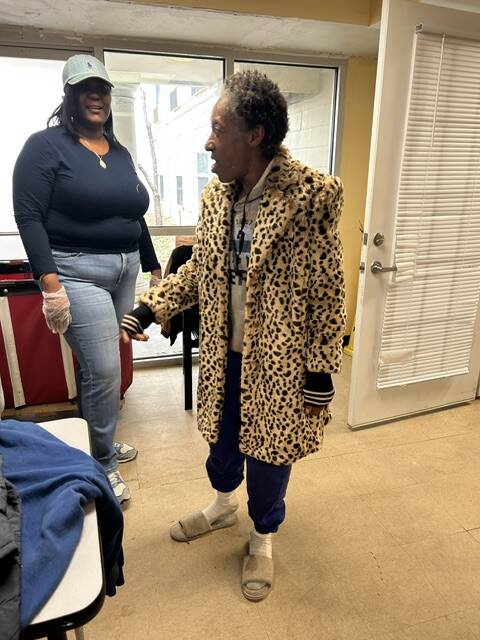 A 3Keys resident of Welcome House in Atlanta tries on his new coat from WSB-TV's Brad Nitz Coat Drive.