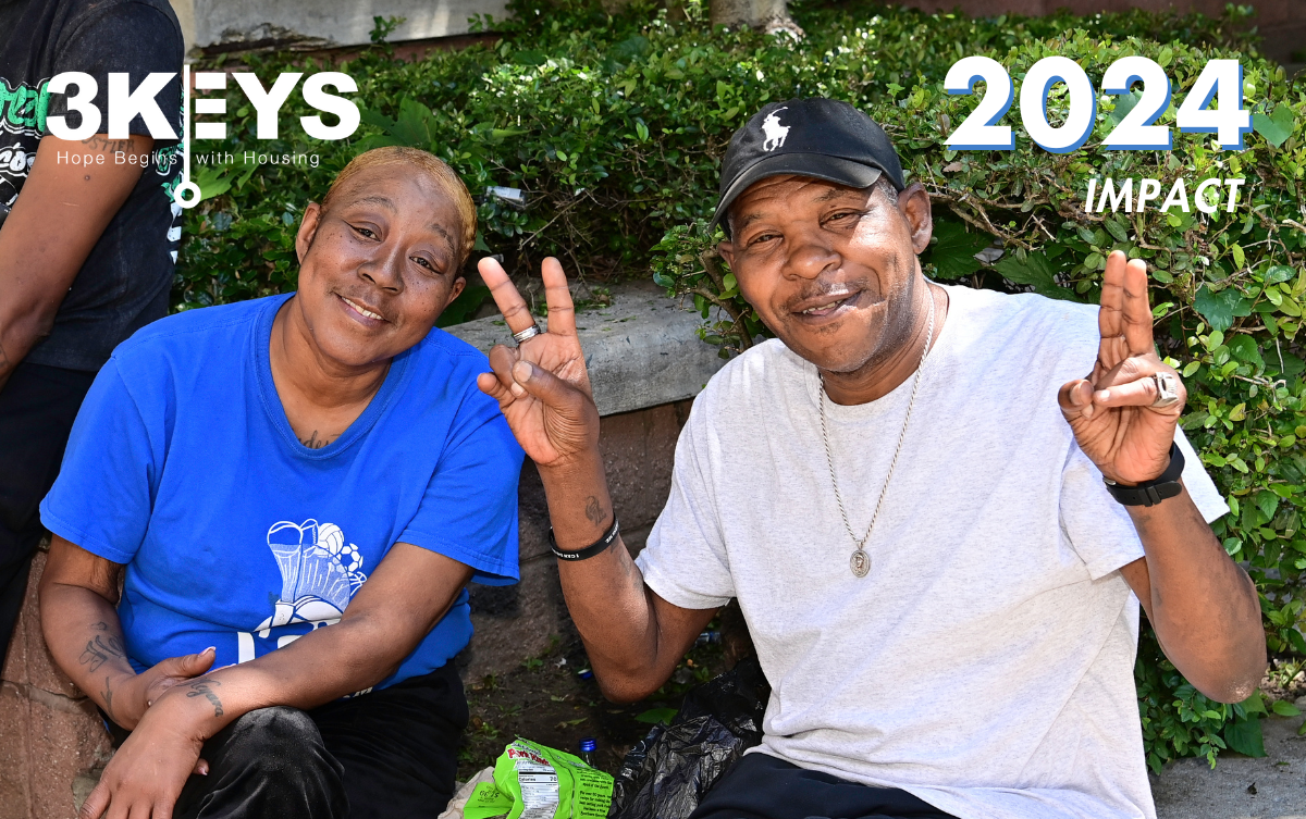 Two 3Keys residents are sitting outside in front of landscaping.