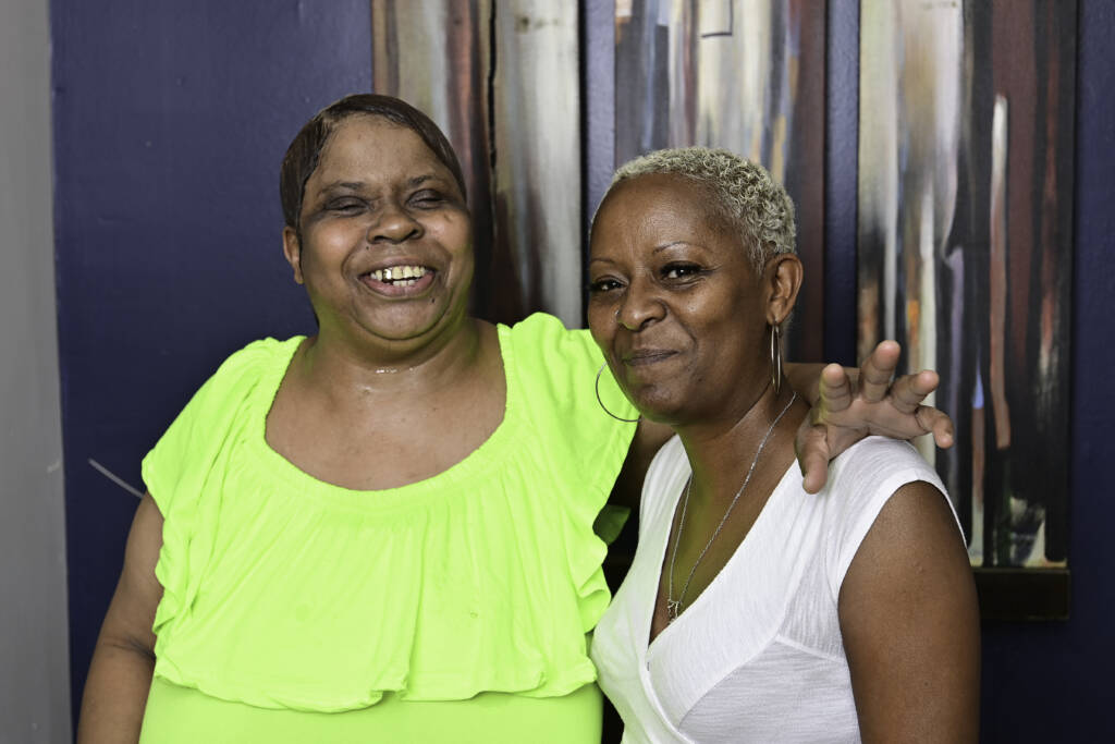 Tyson Bailey stands next to a resident of Welcome House, a permanent supportive housing apartment complex in Atlanta. Photo by Kimberly Evans.