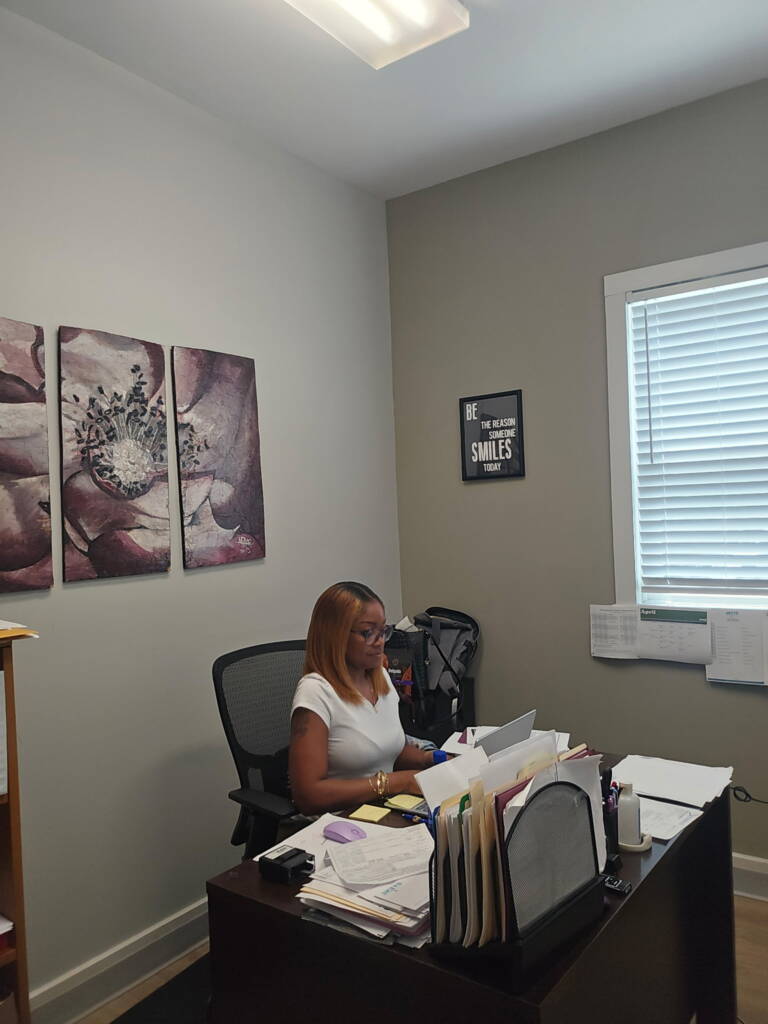 Andrea Pittam, Executive Administrator for The 3 Keys, supports the team from her desk in the office.