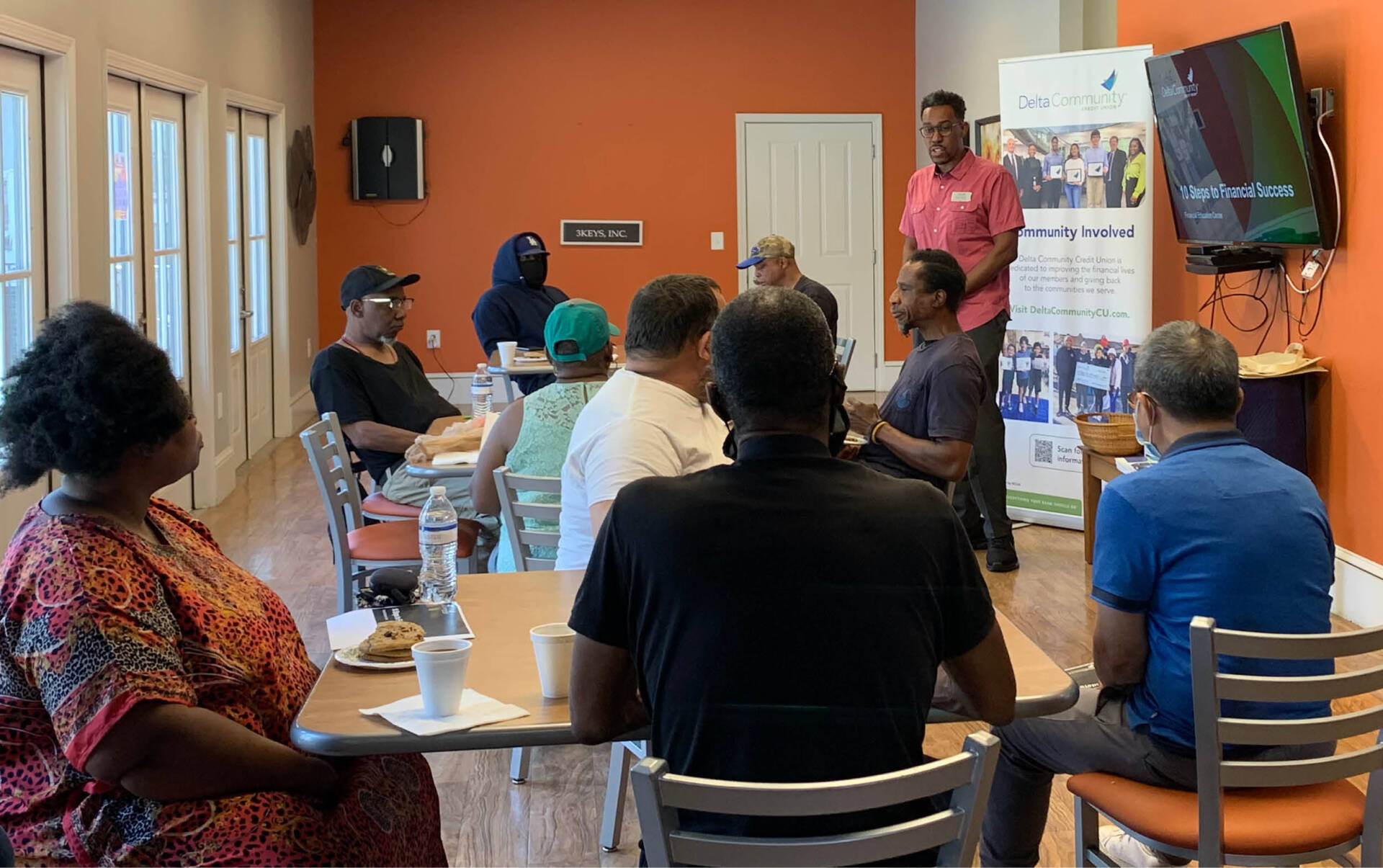 A man from Delta Community Credit Union teaches a financial literacy class to 3Keys residents.