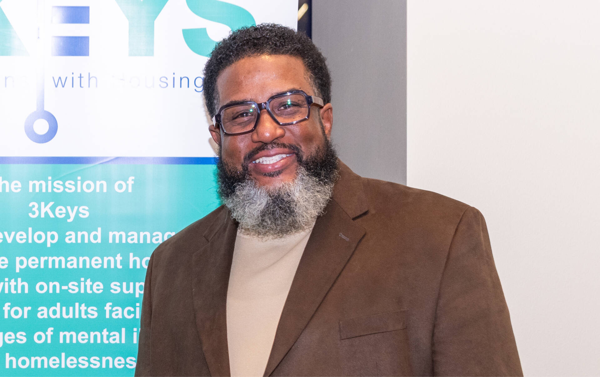 Gerry Richardson, 3Keys' Asset Manager, stands next to a roll-up display banner.