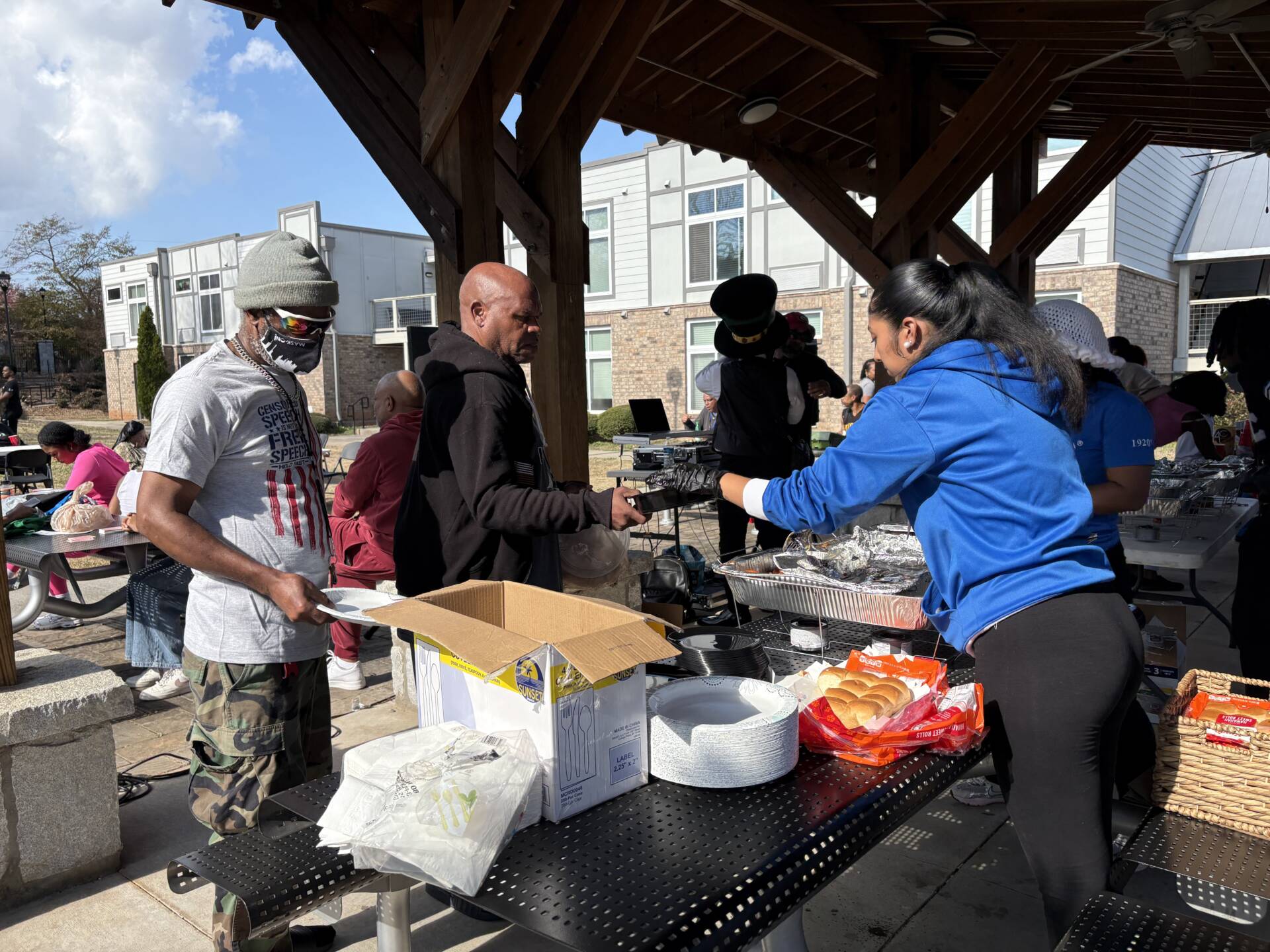Two 3Keys residents stand in line to receive food during H2H's Annual Feed the Hungry event at the Phoenix House.