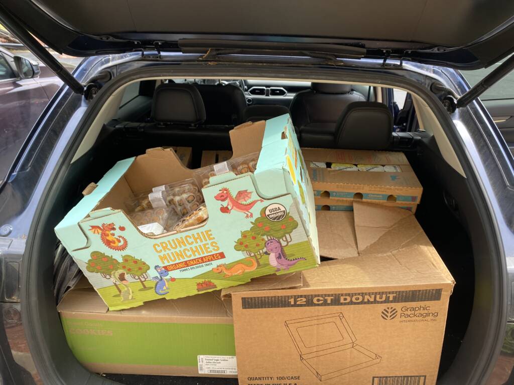 A car trunk is loaded with boxes of food at the 7th Day Adventist Church in Henry County.