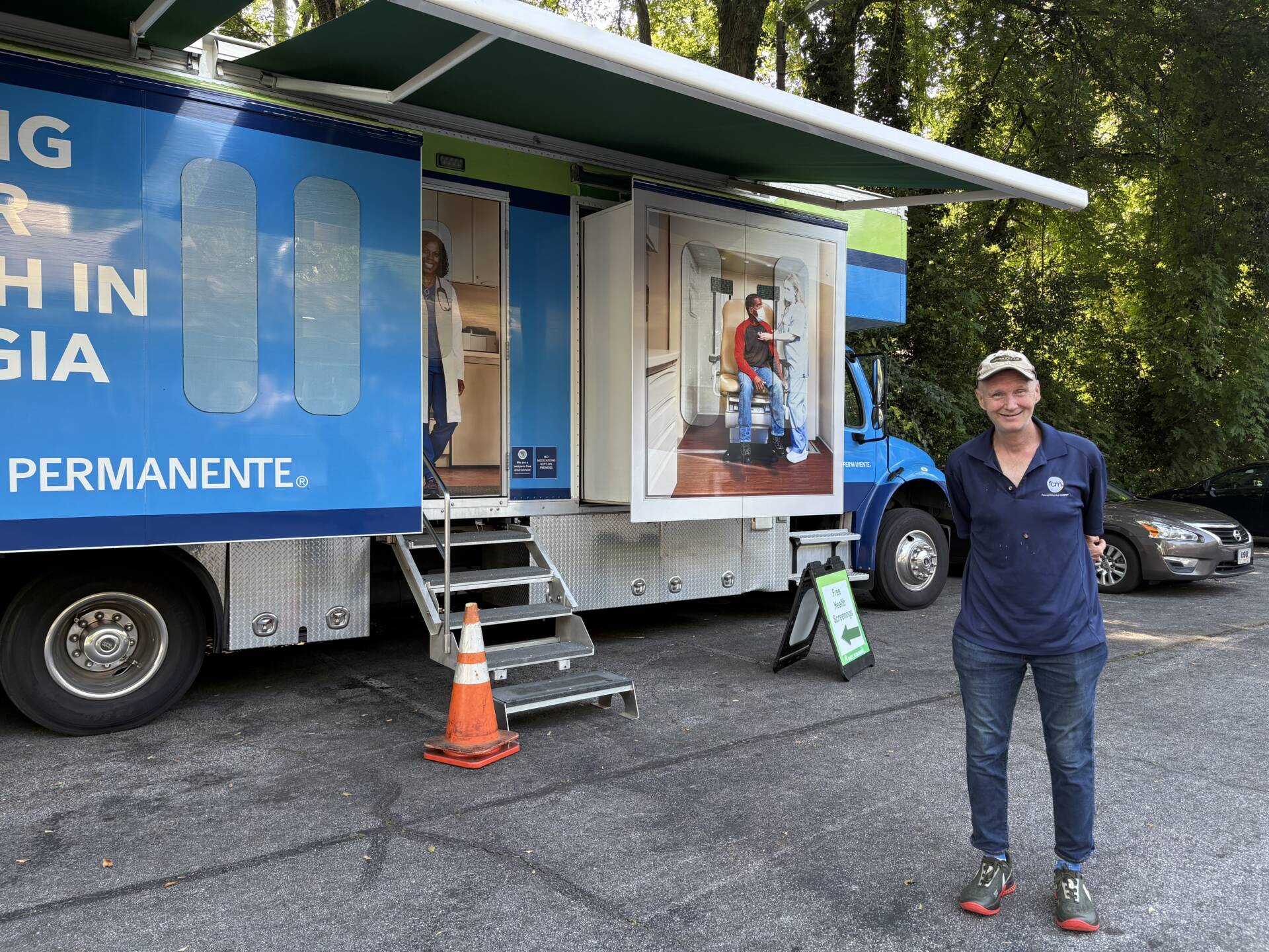A resident of a 3Keys apartment stands in front of the Kaiser Permanente Mobile Health Van in Atlanta, Georgia.