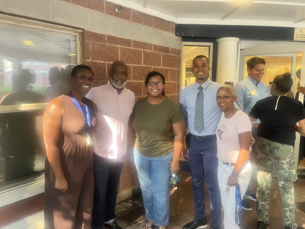Staff of The 3Keys stand in front of Welcome House, an apartment building providing permanent supportive housing for those experiencing homelessness in Atlanta.