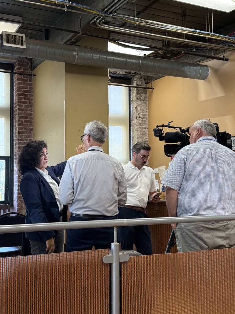 Reporters interview Atlanta City Councilmember Liliana Bakhtiari in the lobby of the O'Hern House.