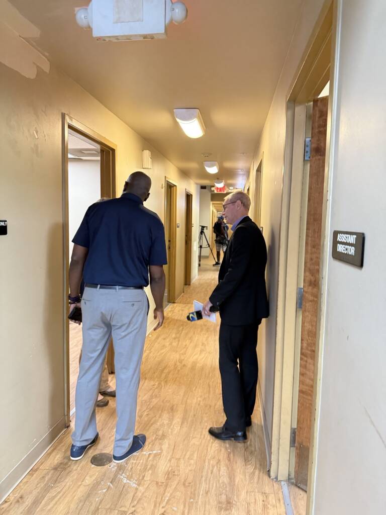 Berndt Petersen, a reporter with WSB-TV, tours O'Hern House with Leonard Adams of Quest CDC.