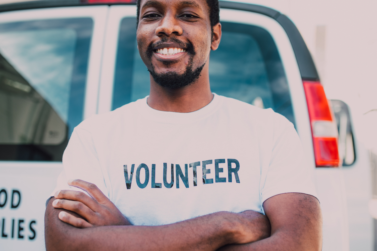 Photo of a man in a t-shirt that says "volunteer"